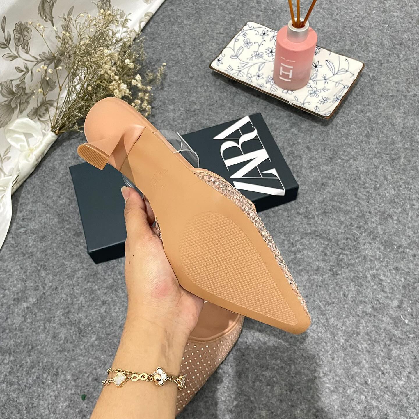 Mesh high-heel mules. Vinyl strap across the instep. Pointed toe