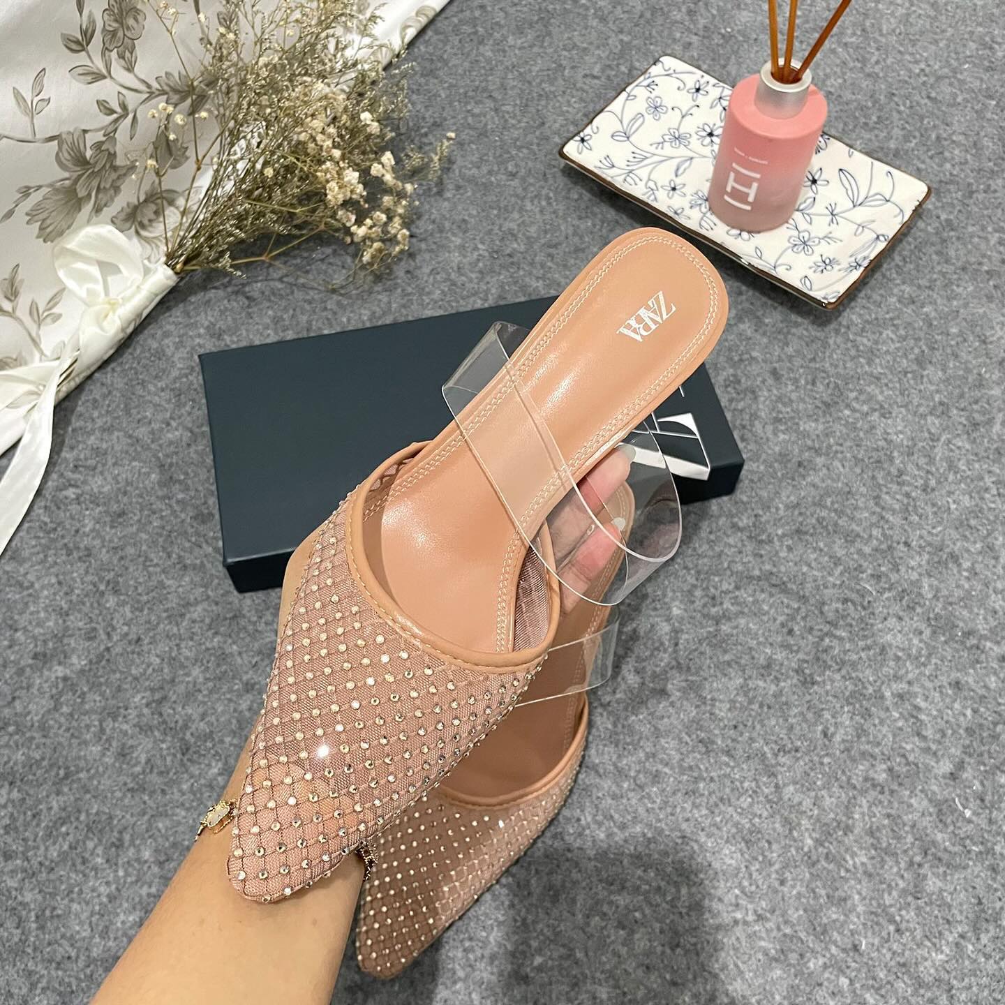 Mesh high-heel mules. Vinyl strap across the instep. Pointed toe
