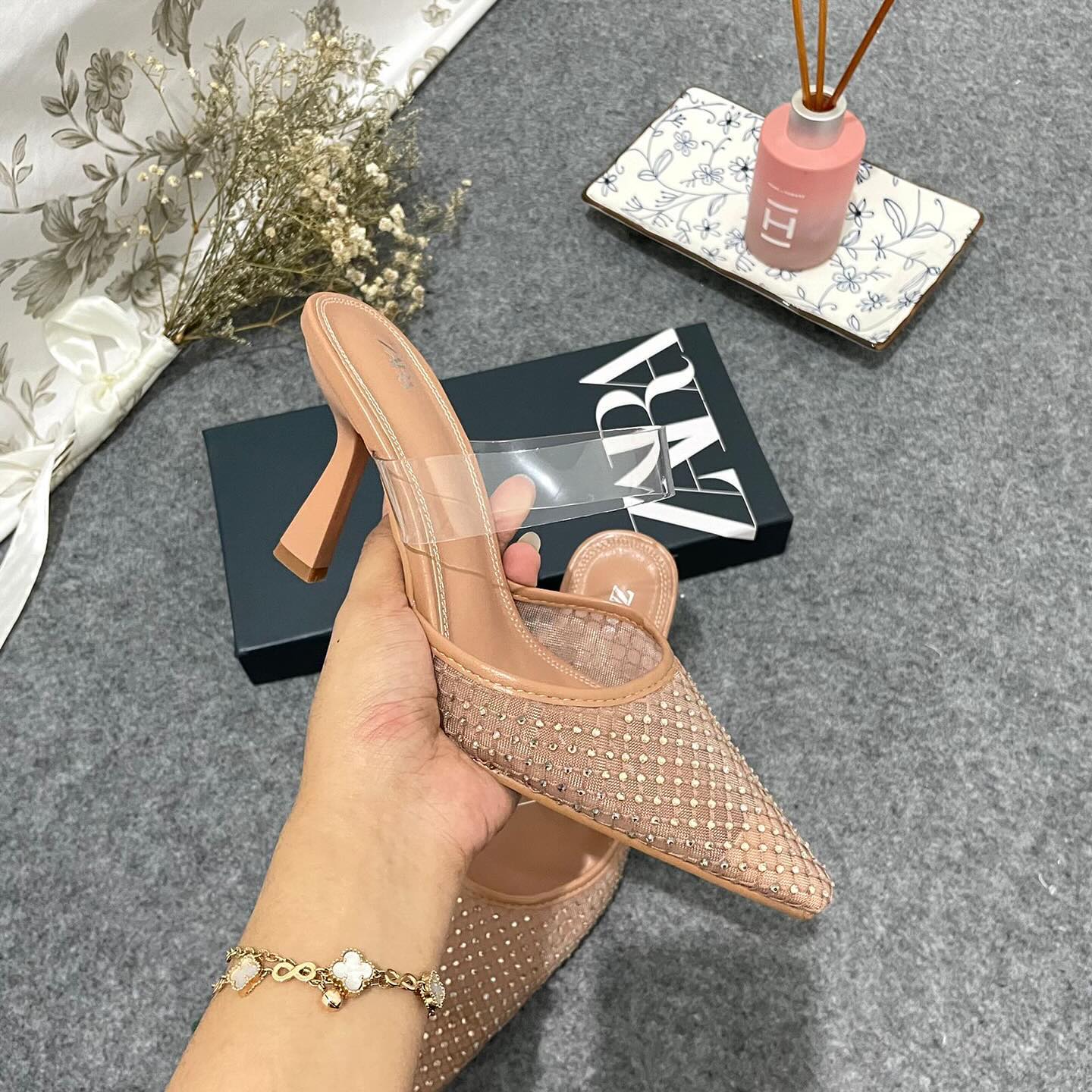 Mesh high-heel mules. Vinyl strap across the instep. Pointed toe